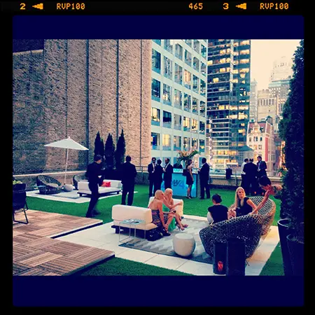 A group of people sitting on top of a green lawn.