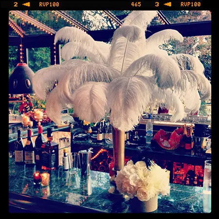 A table with flowers and feathers on it