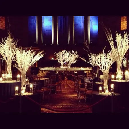 A stage with candles and trees in the middle of it