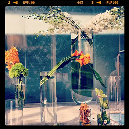 A table with several vases filled with flowers.