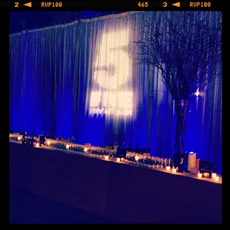 A stage with blue curtains and candles on it